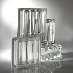 four clear glass containers stacked on top of each other in front of a white background