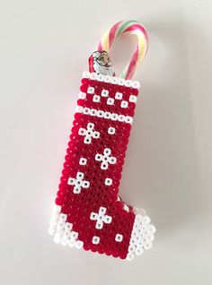 a christmas stocking ornament with candy canes hanging from it's side