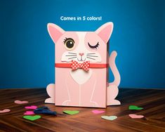 a pink card with a cat wearing a bow tie and confetti scattered around it