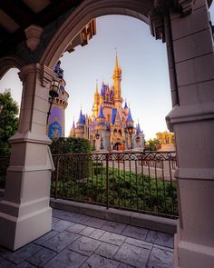 the view from inside an archway at disney's castle