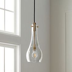 a light bulb hanging from the ceiling in a room with white walls and wooden floors