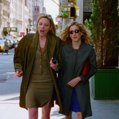 two women are walking down the street together