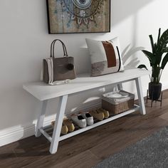 a white bench with shoes and purses on it in front of a large painting