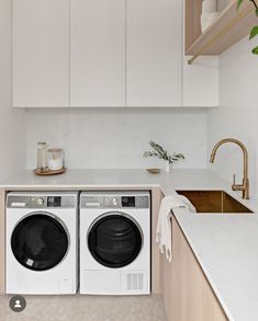 a washer and dryer sitting in a kitchen next to a counter top oven