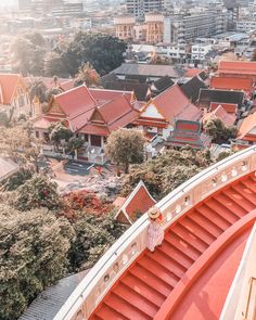 an aerial view of a city with red roofs and stairs leading up to the top