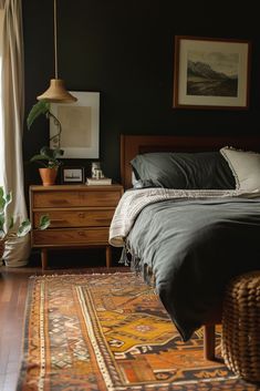 a bedroom with a bed, dresser and rug on the floor in front of a window