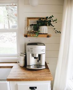 a coffee maker sitting on top of a wooden counter