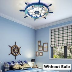 a bedroom with blue walls and plaid bedspread on the bed is lit by a ceiling light