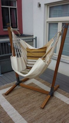 a hammock chair sitting on top of a rug