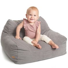 a baby sitting on a bean bag chair