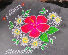 a colorful flower painted on a rock with words written in the middle and below it