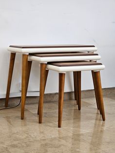 three wooden stools sitting on top of each other