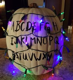 a pumpkin decorated with christmas lights and letters