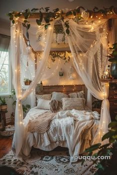 a bed with white curtains and lights on it