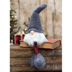 a stuffed gnome sitting on top of an open book