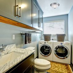 a washer and dryer in a bathroom with marble counter tops on the floor