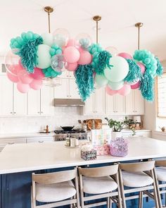 balloons and streamers are hanging over the kitchen island