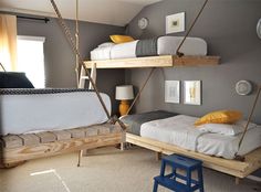 a bedroom with bunk beds and swings in it