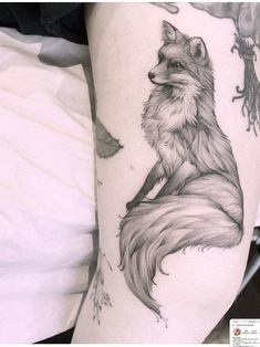 a woman's thigh with a tattoo of a fox sitting on top of it