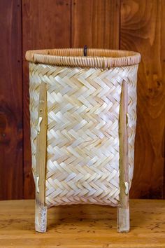 a woven basket sitting on top of a wooden table