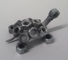 nuts and bolts are stacked on top of each other to form the shape of a turtle