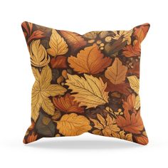 an orange and brown pillow with leaves on it