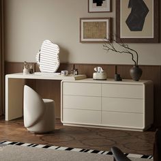 a white dresser sitting in a living room next to a window with pictures on the wall