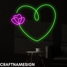 a heart shaped neon sign with a flower in the center on a black wall next to a chair