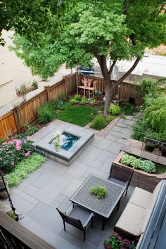 Backyard garden with a small pond, seating area, and a large tree providing shade. Small Backyard Decor Ideas, Small Backyard Decor, Cozy Courtyard, Backyard Decor Ideas, Small Backyard Ponds, Outdoor Projector Screen, Small Water Features, Outdoor Projector, Pond Landscaping