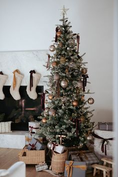 a christmas tree with stockings hanging from it