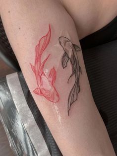 a woman with a tattoo on her leg has a fish in it's stomach