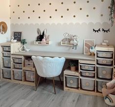 a child's room with white furniture and gold polka dot decals on the wall