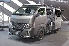 a silver van is on display at an auto show