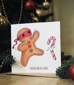 a christmas card with an image of a gingerbread man and candy canes on the table