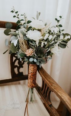 a bouquet of flowers sitting on top of a wooden chair