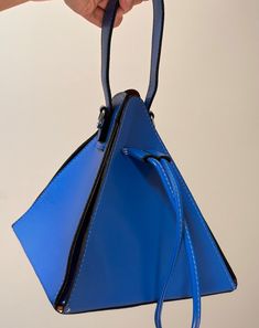 Measurements: 7.87 inches x 7.87 inches Unique blue triangle bag to elevate your look.  Blue bag triangular blue bag statement bag  blue statement bag 2024 Accessories, Triangle Bag, Unique Purses, Statement Bag, Top Handle Bags, Vegan Leather Bag, Cute Earrings, Blue Bags, Slow Fashion