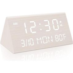 an alarm clock with the time displayed on it's display stand, in front of a white background