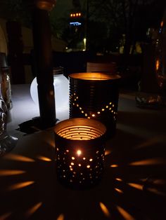 two lit candles sitting on top of a table