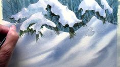 someone is painting a snowy mountain scene with watercolors