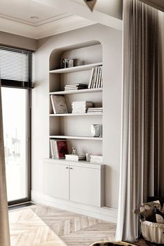 a white book shelf in the corner of a room