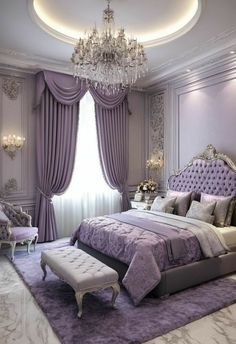 a bedroom decorated in lila tones with chandelier, bed and ottoman on the floor