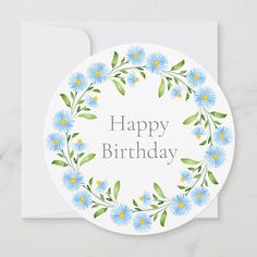 a white card with blue flowers and the words happy birthday