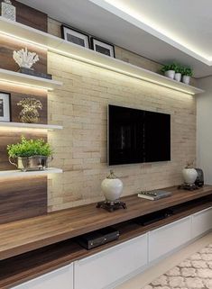 a living room filled with furniture and a flat screen tv on top of a wooden shelf