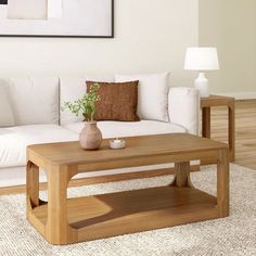 a living room with a white couch and wooden coffee table