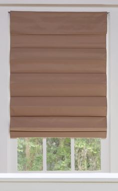 a tan roman blind in front of a window