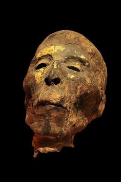 an old mask is shown against a black background