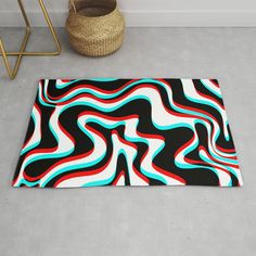 a black, white and blue rug with wavy lines on it next to a basket