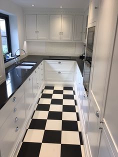 a black and white checkered floor in a kitchen