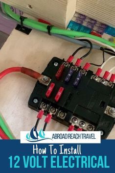 an electrical panel with wires and plugs attached to it, on top of a table