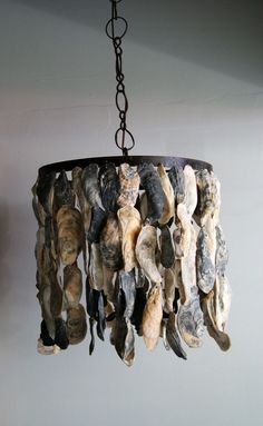 a chandelier made out of shells hanging from a ceiling